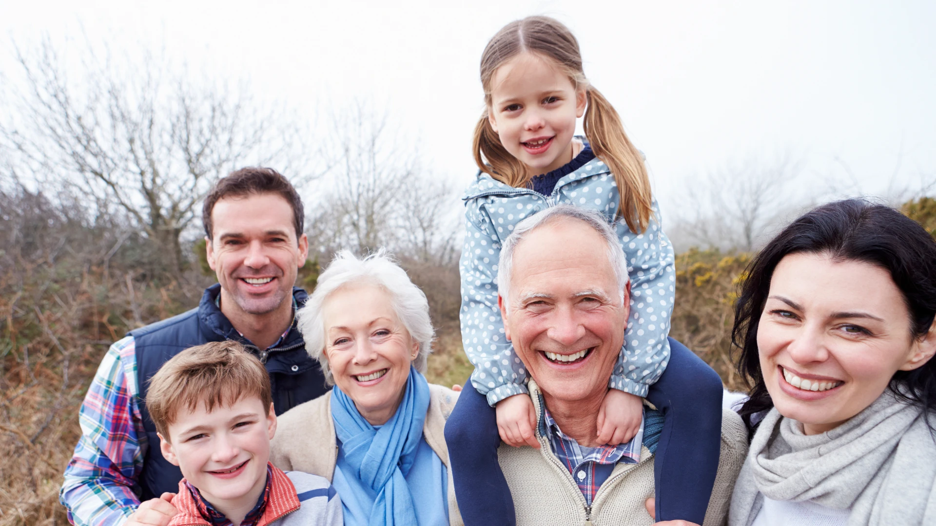 Happy multi-generational family enjoying time outdoors together.