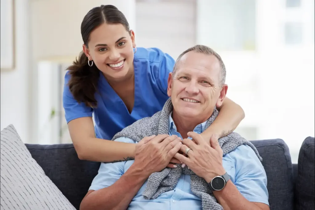 Kind caregiver assisting elderly patient with a smile – personalised home care in Truro & Swindon