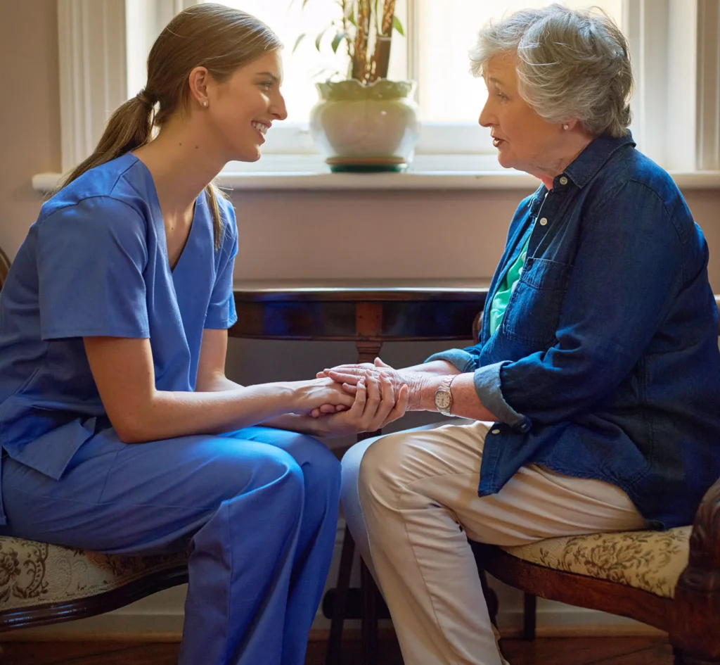 Kind caregiver comforting elderly client during home care visit in Swindon