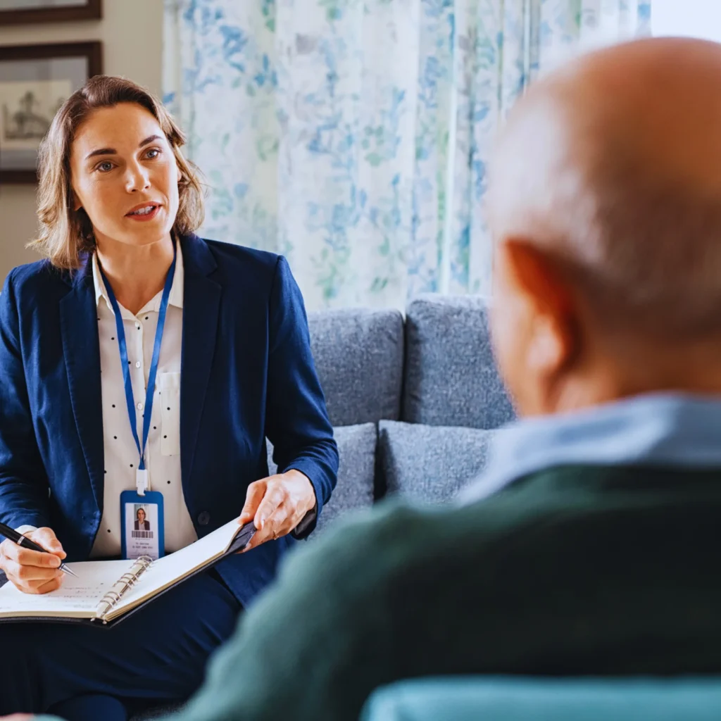 Professional care consultant discussing home care options with an elderly client.