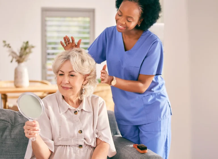 Female carer styling senior woman's hair as part of personal grooming home care in Truro and Swindon.