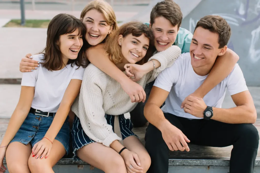 Support workers engaging with smiling young adults in Truro & Swindon supported living program