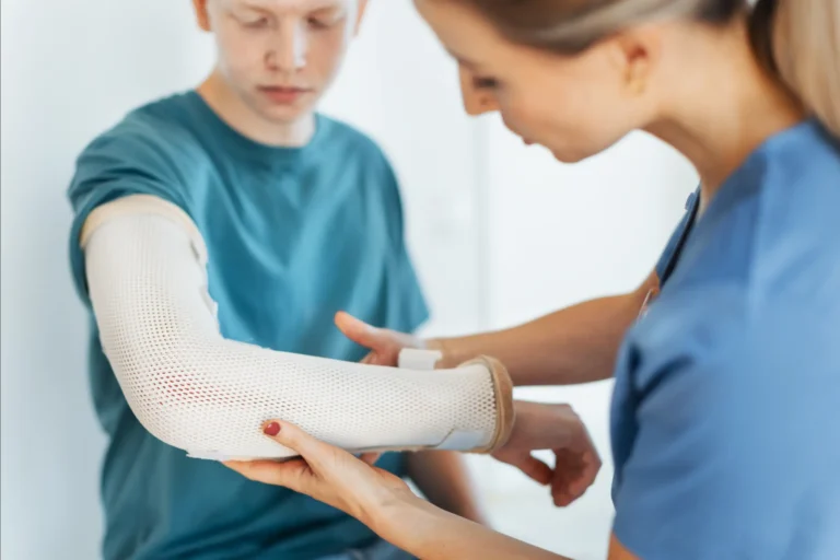 Healthcare specialist examining orthopedic brace for young adult in Truro TDDI care program