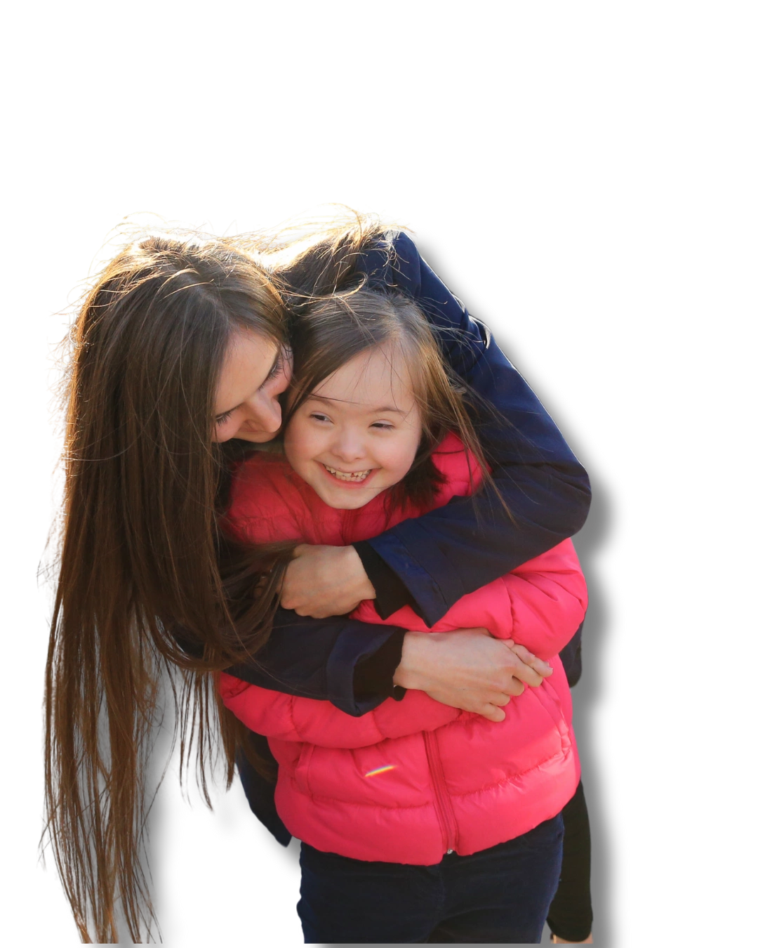 Young woman hugging a smiling child with Down syndrome