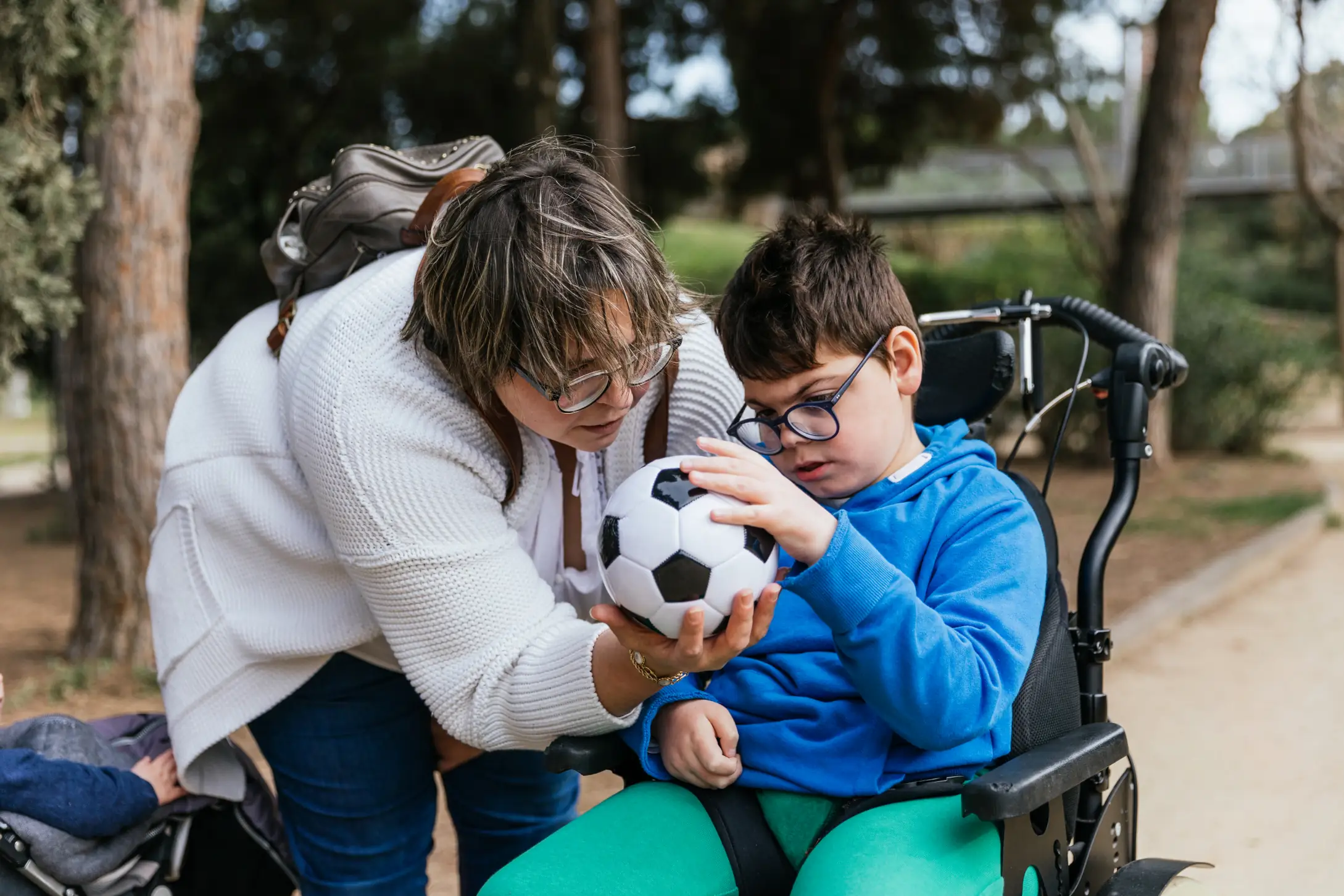 A child with multiple disabilities in a wheelchair receives compassionate care in Truro